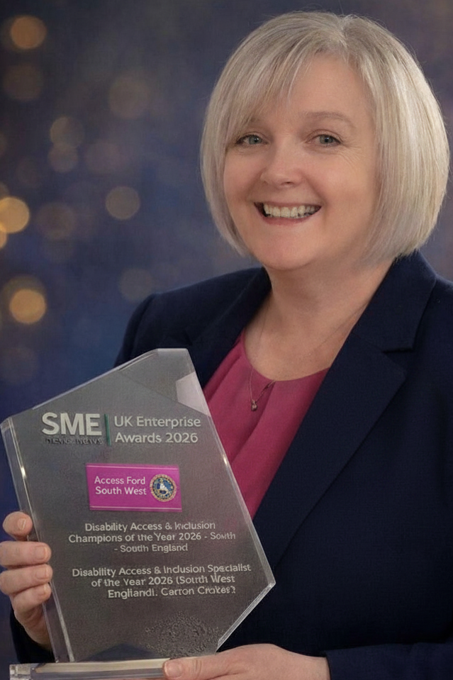 Carron holding the glass trophy for the SEM Award 2026